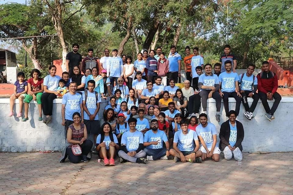 The Pune chapter, several dozen strong, gathered on a low wall under the trees.